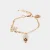 Bracciale in Metallo con campanella portafortuna pendente smaltata bianca e dettaglio a forma di fiore smaltato bianco 3171877