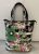 Borsa maxi shopper nera con righe bianche e fantasia di fiori modello SELZ in telone camion Paul Meccanico
